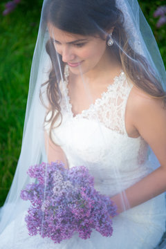portrait of happy beautiful bride in wedding dress with long vei