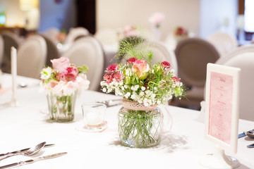 Table set in pink and white for wedding or event party.