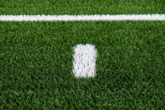 White line on green football field, outdoor stadium