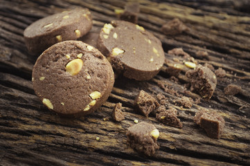 Chocolate cookies on old wooden background