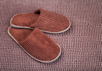 Brown wool slipper on mat