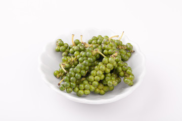 green color black pepper on white background