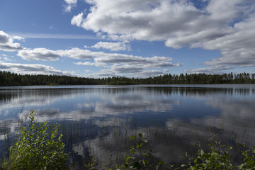 A fishing lake in the wilderness of north sweden with reflections from the sky