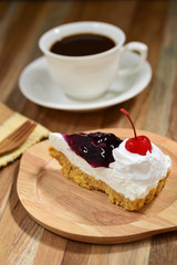 slice of blueberry cheese cake on wooden table