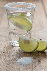 Tequila shot with lemon on the table, selective focus