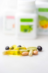 Mixed food supplement pills close-up, omega3, carotine, vitamins