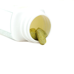 Dietary supplement multivitamins green pills on white background