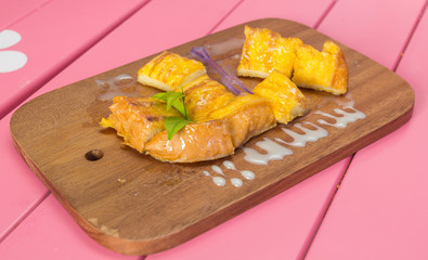 french toast with butter and milk on Wooden pink background