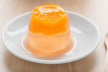 Orange jelly on white dish