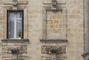 Obraz premium Real Window, Blank Window. Often in the last century windows were taken out and replaced with walls. Here the window has gone but not the elaborate frame and ornaments.