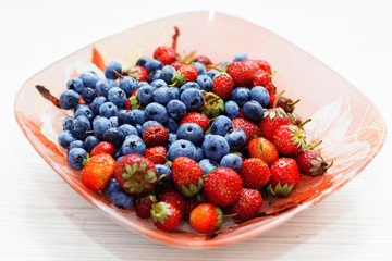 Blueberry and strawberry  summer fruits on plate