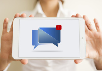 woman hands holding a white tablet with notification icon