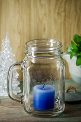 Blue candle in bottle glass
