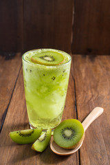 kiwi smoothie with fresh fruits on wooden background