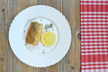 Top view of the plate with fried fish 