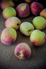 group of fresh peaches on wood background
