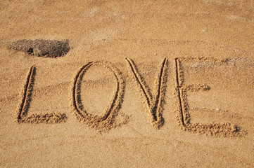 The word Love written in the sand on the beach