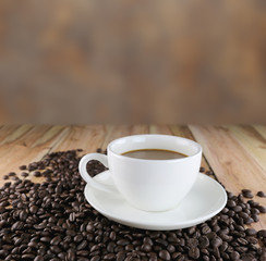 White coffee cup and roasted coffee beans.