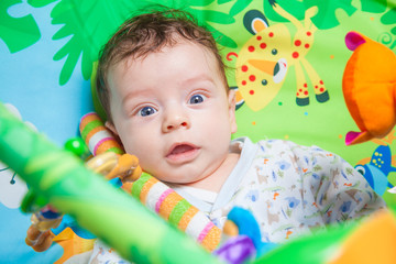 Baby boy on playmat