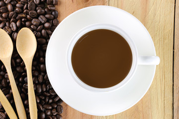 White coffee cup and wooden spoon.