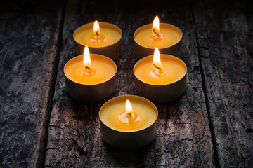 scented candles burning on a wooden background