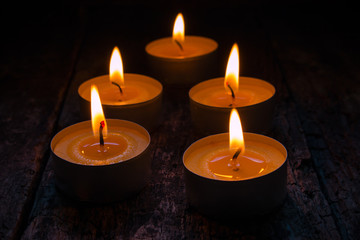 scented candles burning on a black background