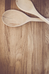rough wood kitchen tools on a natural wood background - spoons
