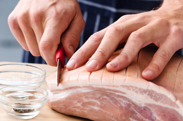 Hands preparing meat for roasting, butcher chef cook
