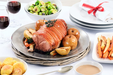 Pork roast dinner with vegetable, potato sides and wine