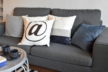 living room with row of black and white pillows on sofa at home