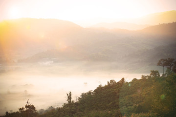 Abstract blurry foggy sea with sun rise flare on the mountain of Thailand
