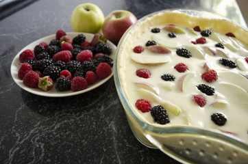 Preparing of home made pie with berries and apples. Cooking process.