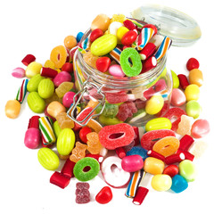 Glass jar full of candies isolated in white background
