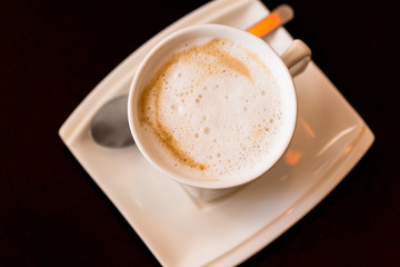Top view of Hot coffee in white cup on black background
