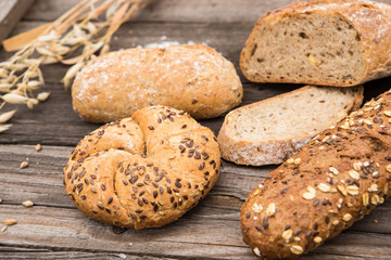Rustic bakery and wheat on an old vintage planked wood table.