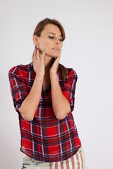 thoughtful woman in plaid shirt