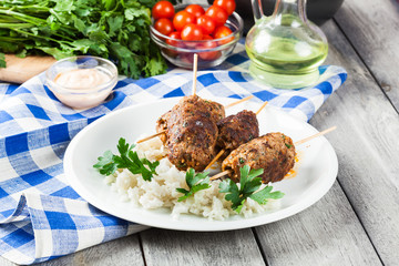 Barbecued kofta with rice on a plate
