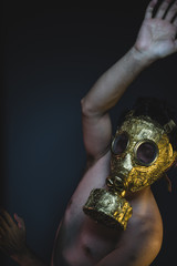 environmental, depression and danger man with golden gas mask