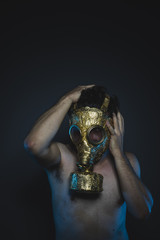 safety, depression and danger man with golden gas mask