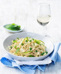 Pasta with olive oil and green vegetables with glass of wine