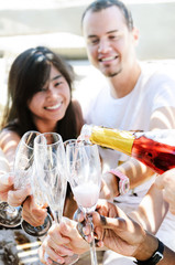 Smiling friends celebrating a special occasion with drinks