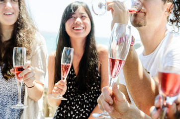 Smiling friends celebrating a special occasion with drinks