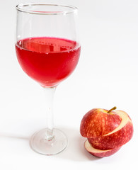 Red apple and red water on white background.