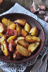 Baked potato with bacon, rosemary, olive oil and sea salt