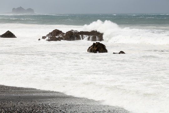 Stormy sea during typhoon, waves breaking over rocks