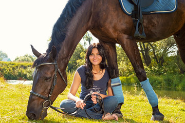 Portrait of a beautiful smiling woman with a horse on nature.