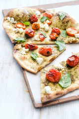 Thin crust pizza with roasted tomatoes