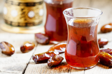 Two cups of black tea  in traditional Islamic cups with sweet da
