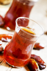 Two cups of black tea  in traditional Islamic cups with sweet da