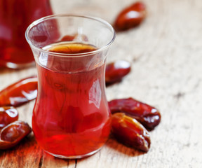 Two cups of black tea  in traditional Islamic cups with sweet da